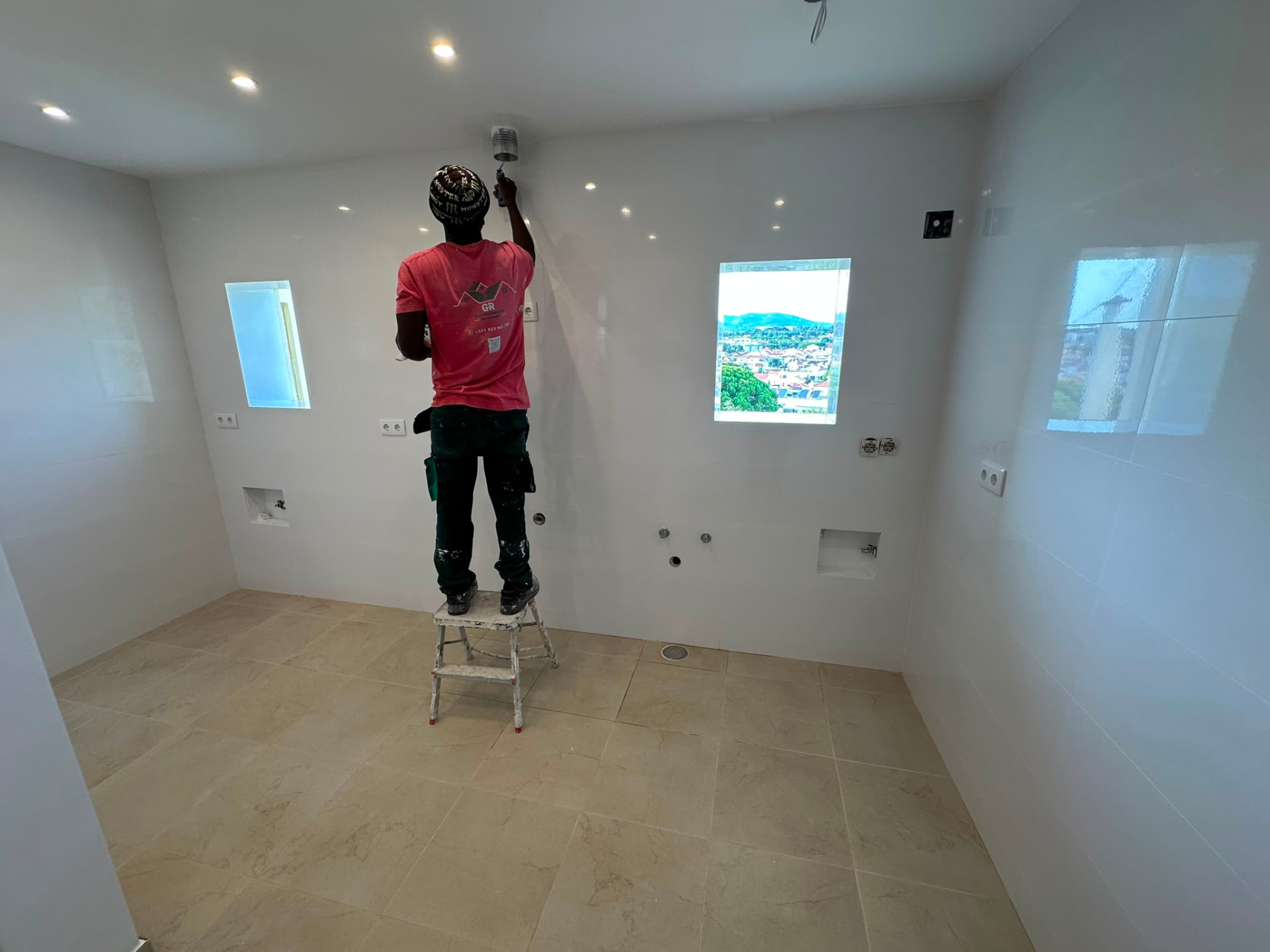 Equipa GR Remodelações a pintar o teto de uma cozinha em obra