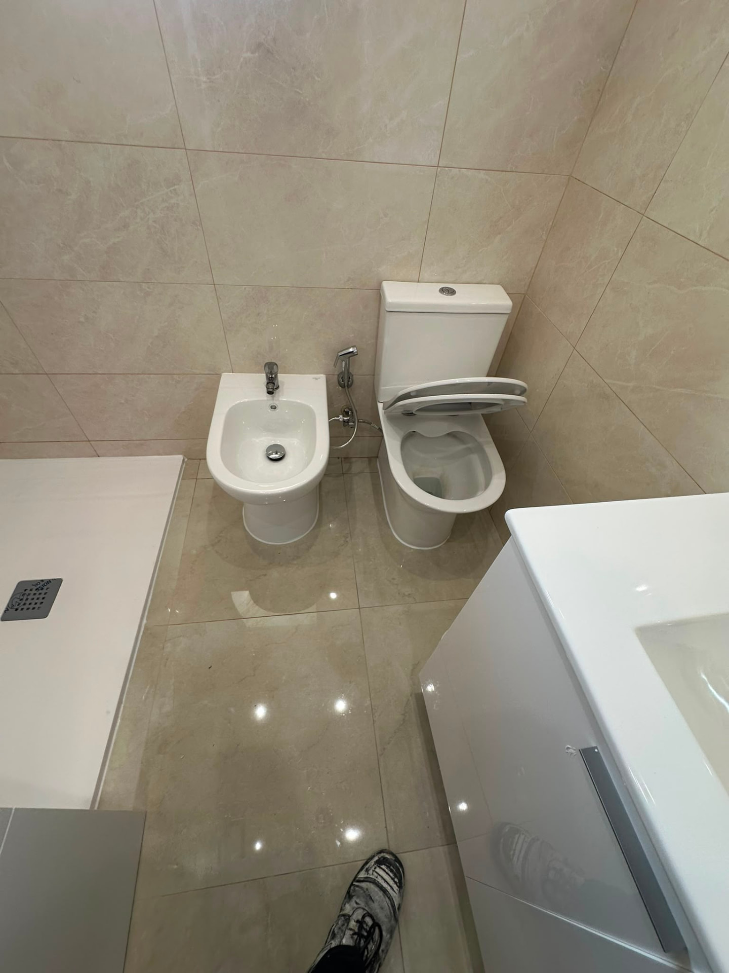 Casa de banho remodelada com sanita, bidé e móvel de lavatório novos